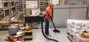 Water Damage Restoration Technician Cleaning After Garage Flooding